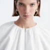 Blusa de popelín de algodón con cremallera frontal