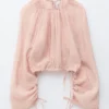 Blusa voluminosa con detalle de lazos