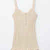 Camiseta sin mangas con dobladillo festoneado