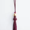 Dije de bolso con borla de cuero