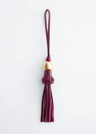 Dije de bolso con borla de cuero