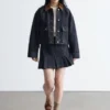 Minifalda de denim plisada