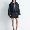 Minifalda de denim plisada